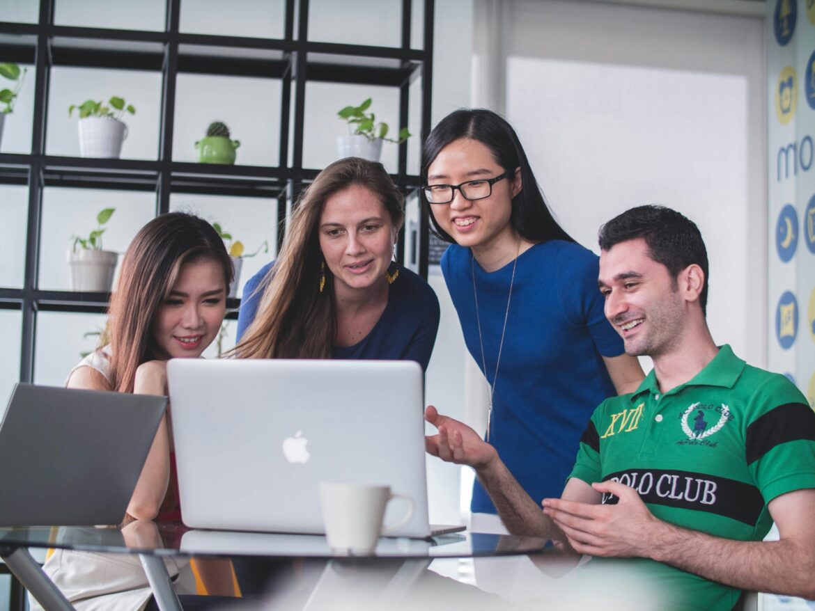 Happy students learning digital skills on their computer